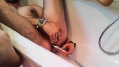 Bi-guy using shower head, squirting water, enema