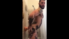 Tatted Hunk Fucks Dildo In Shower Until He Cums