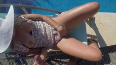 Outdoor solo masturbation scene with curly blonde